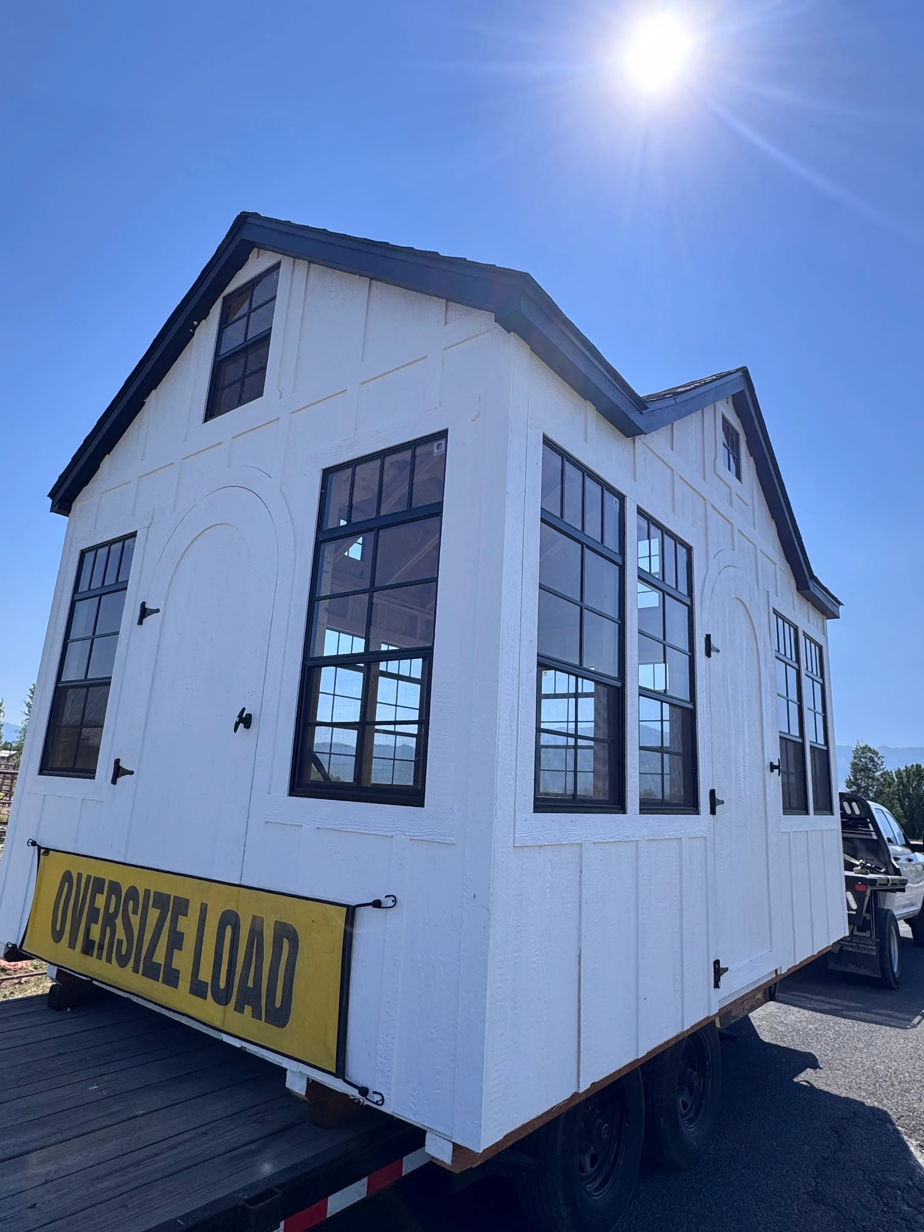 White gambrel roof shed Logan Utah