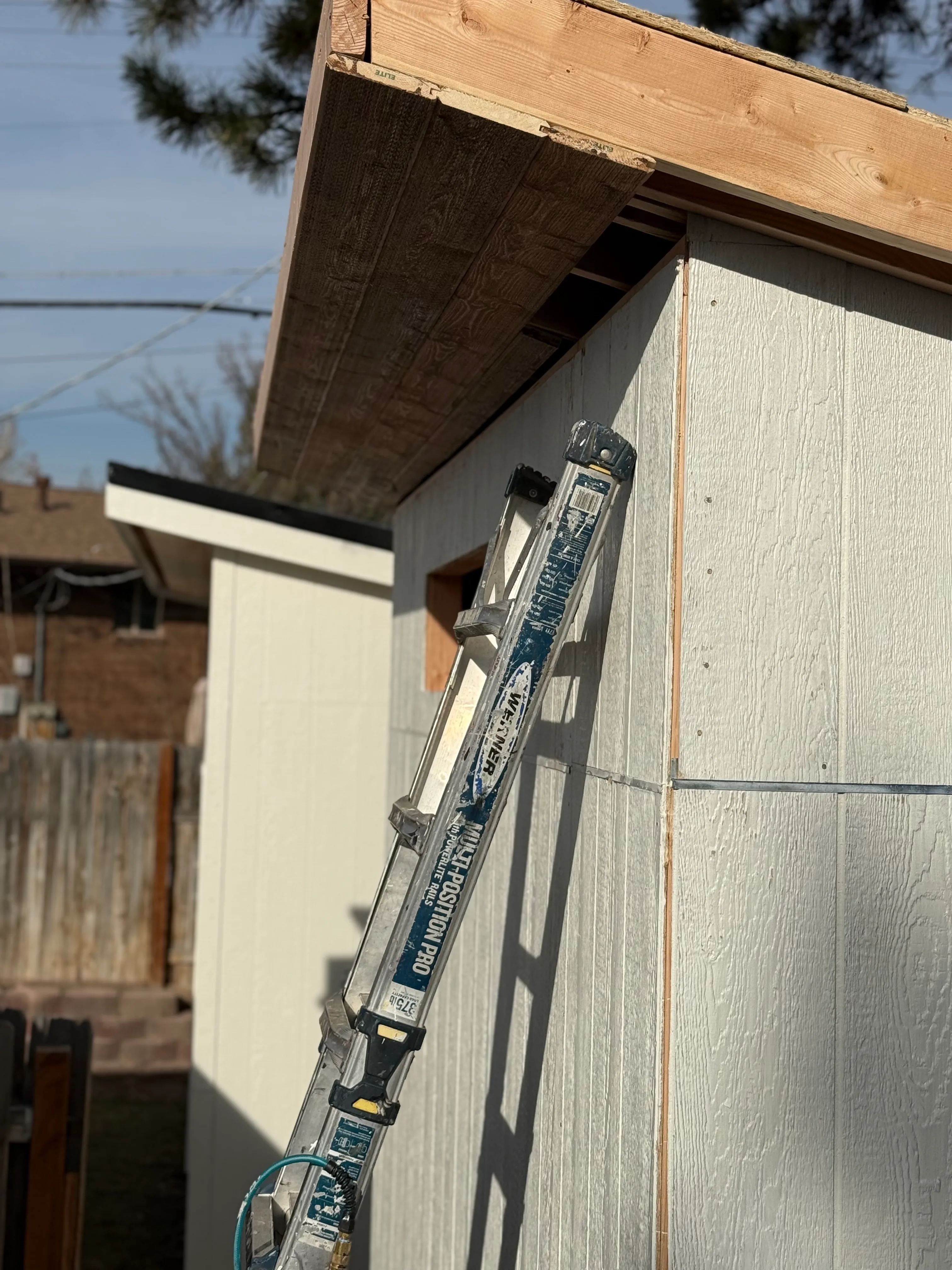 Shed siding installation in progress